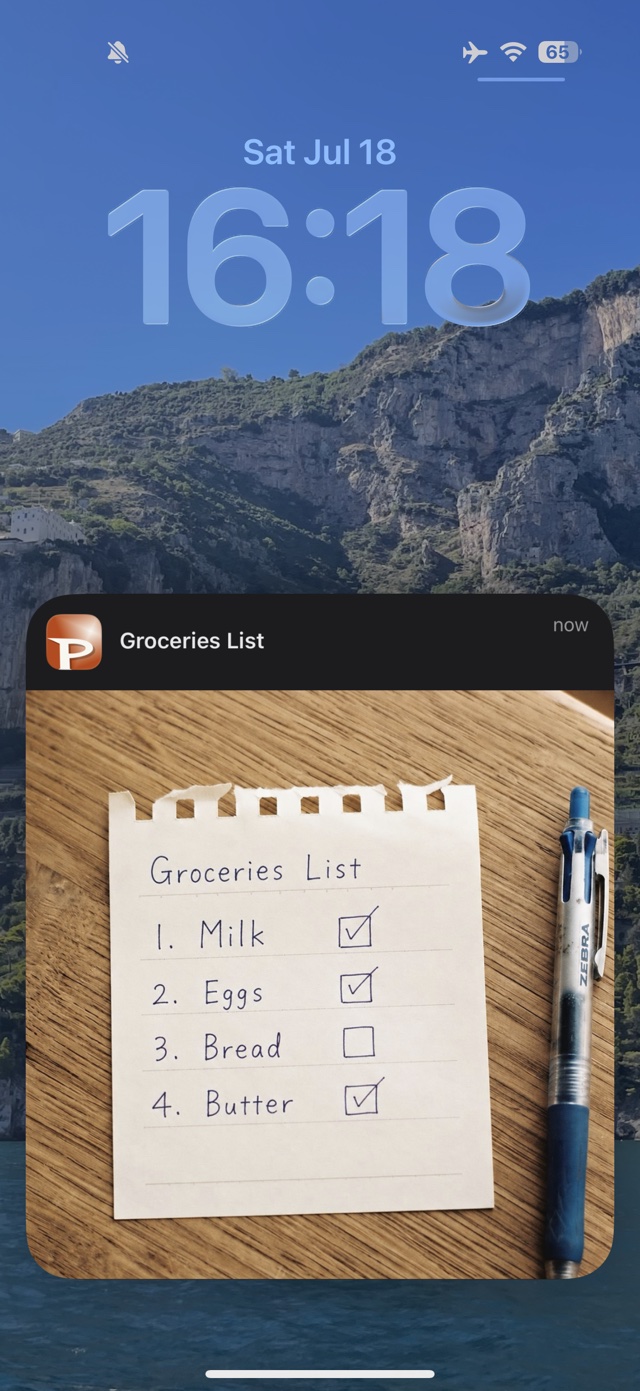 A lock screen showing a PicCue notification with a photo of a groceries list displayed right in the banner
